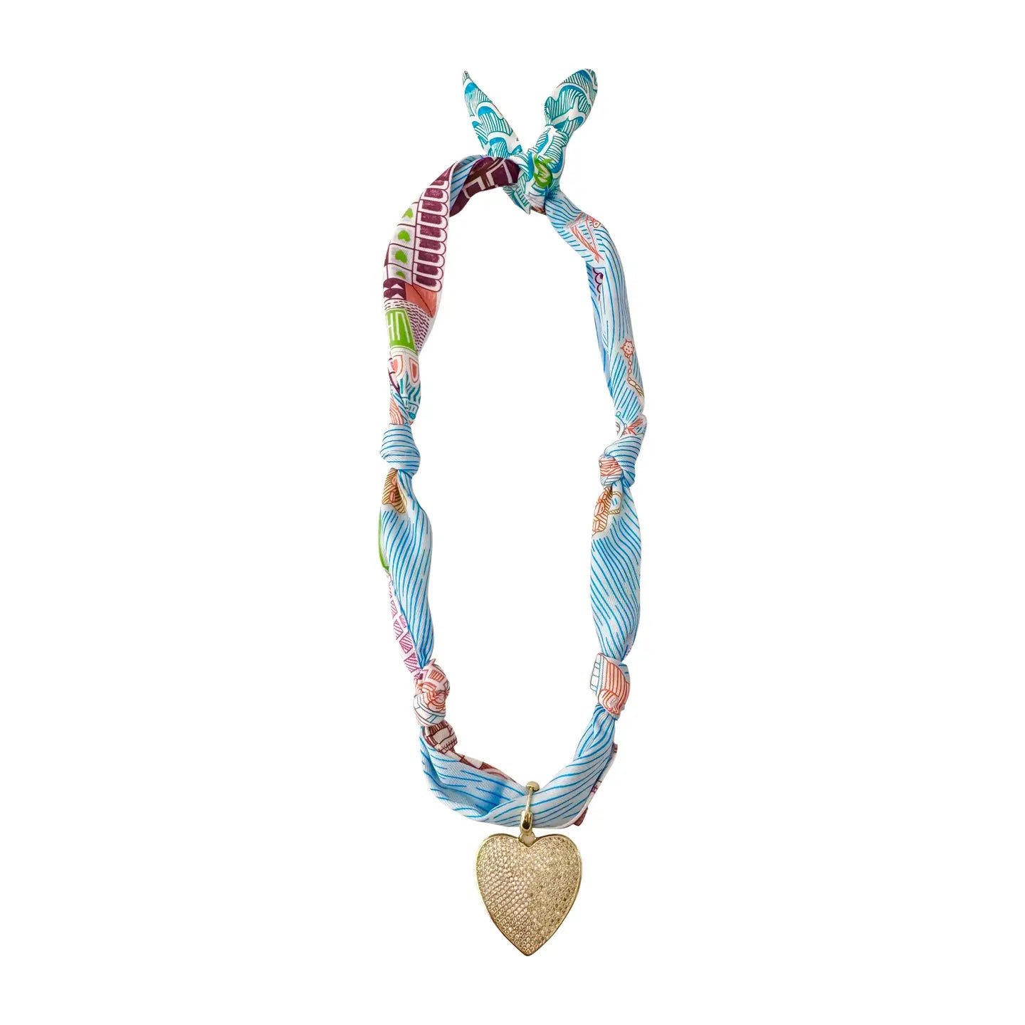 A gold-plated heart charm necklace with a multicolored scarf attached to it.